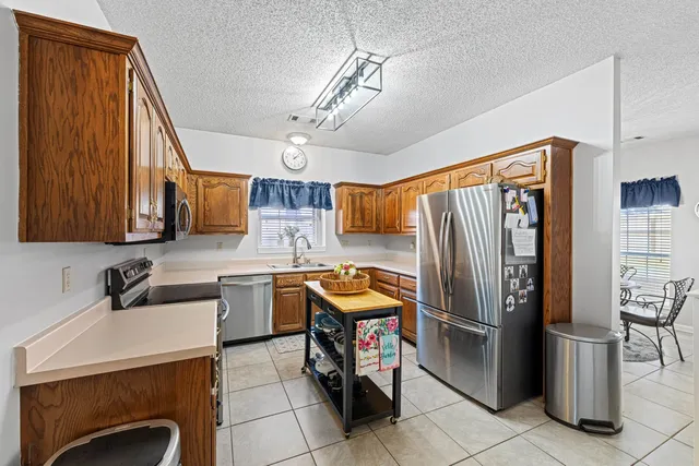 a kitchen with a refrigerator a sink and dishwasher