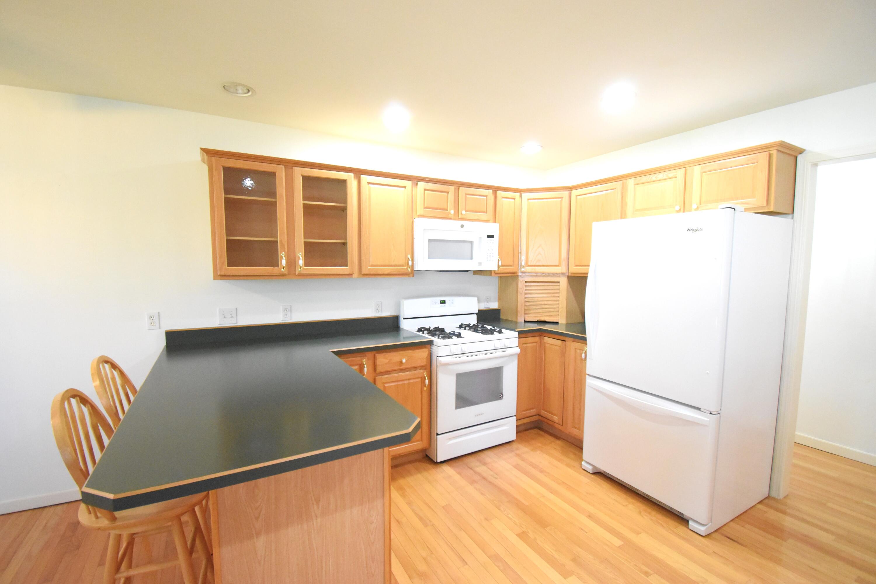 522 Pheasant Run Rensselaer, IN 47978 - Photo 29 of 55 a kitchen with granite countertop a refrigerator and a stove top oven