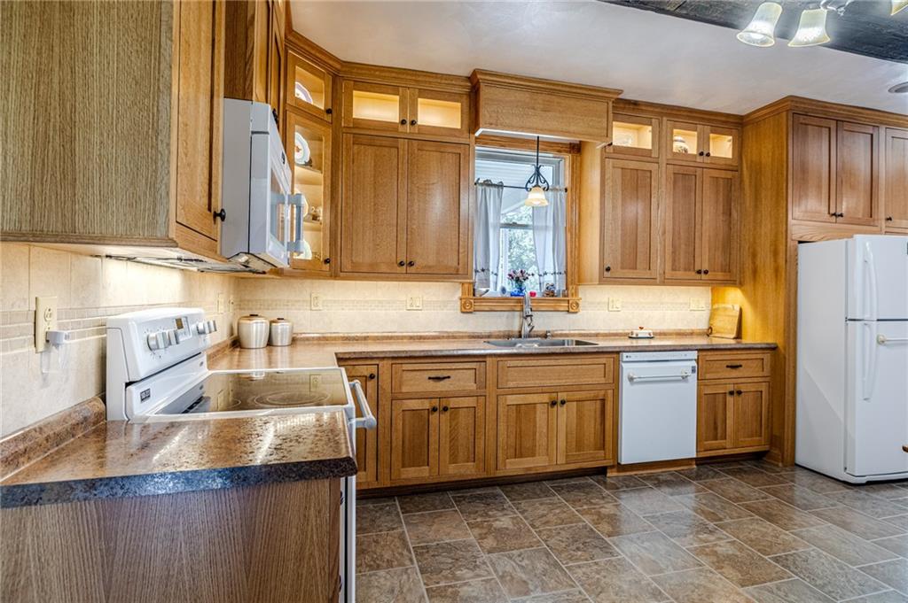 440 Owl Hollow Road Ligonier, PA 15658 - Photo 11 of 49 a kitchen with stainless steel appliances granite countertop a sink and a refrigerator