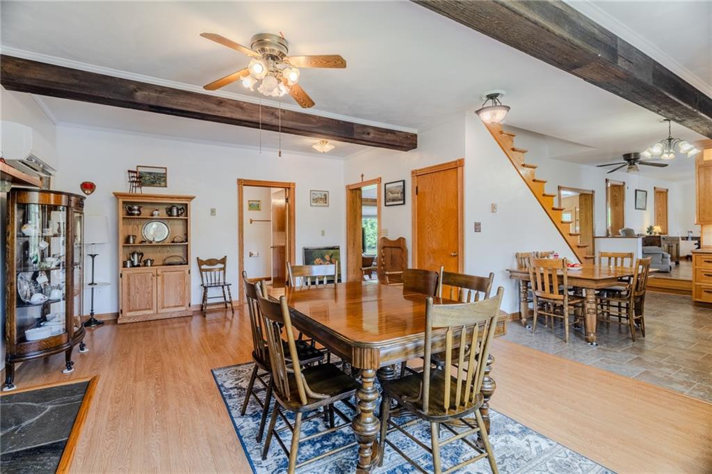 440 Owl Hollow Road Ligonier, PA 15658 - Photo 14 of 49 a dining room with wooden floor a chandelier a wooden table and chairs