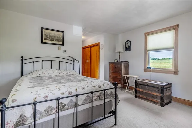 a bedroom with a bed and a tv