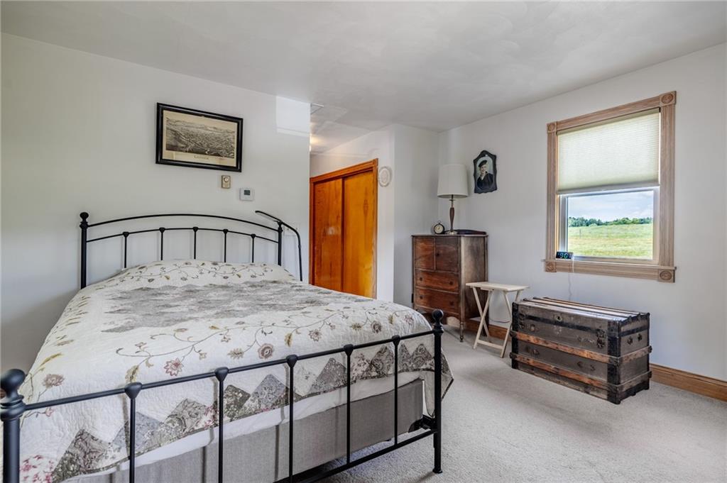 440 Owl Hollow Road Ligonier, PA 15658 - Photo 24 of 49 a bedroom with a bed table chair and a window