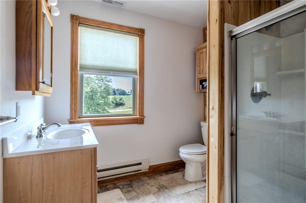 440 Owl Hollow Road Ligonier, PA 15658 - Photo 25 of 49 a bathroom with a granite countertop sink toilet and shower