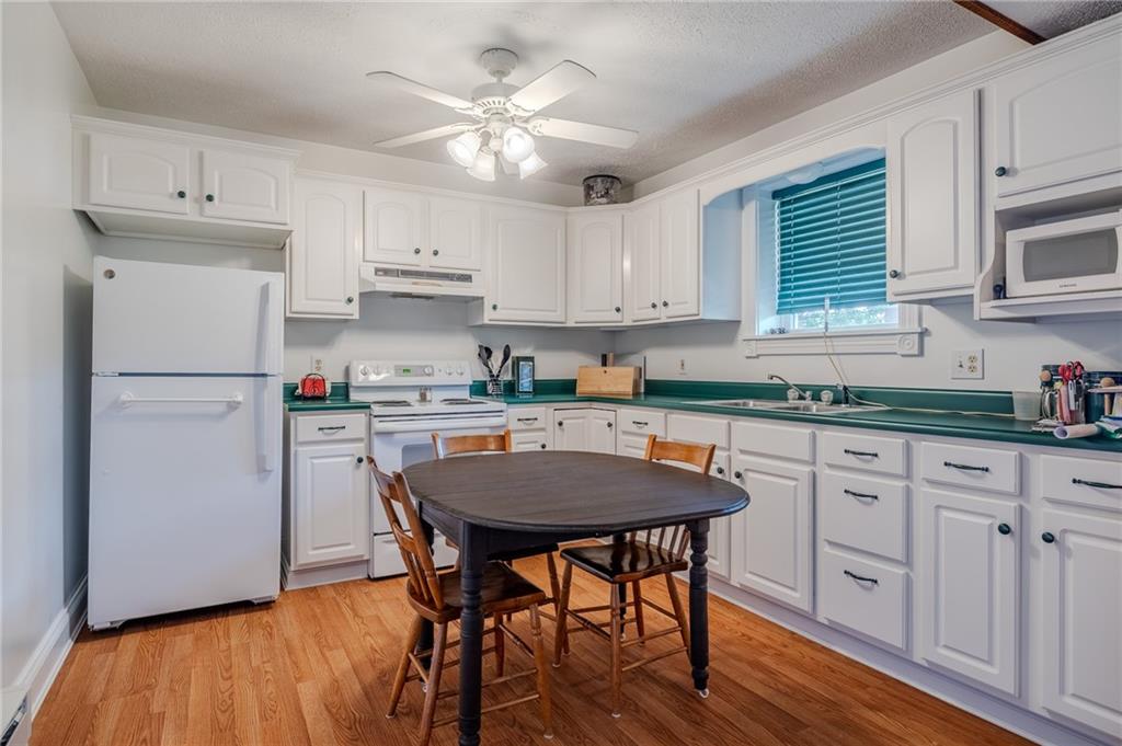 440 Owl Hollow Road Ligonier, PA 15658 - Photo 30 of 49 a kitchen with cabinets wooden floor and stainless steel appliances