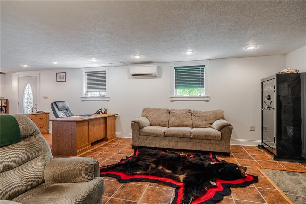 440 Owl Hollow Road Ligonier, PA 15658 - Photo 31 of 49 a living room with furniture window and a flat screen tv