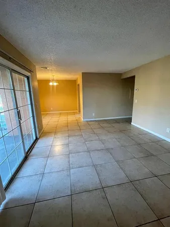 a view of a livingroom with an empty space and the sink window