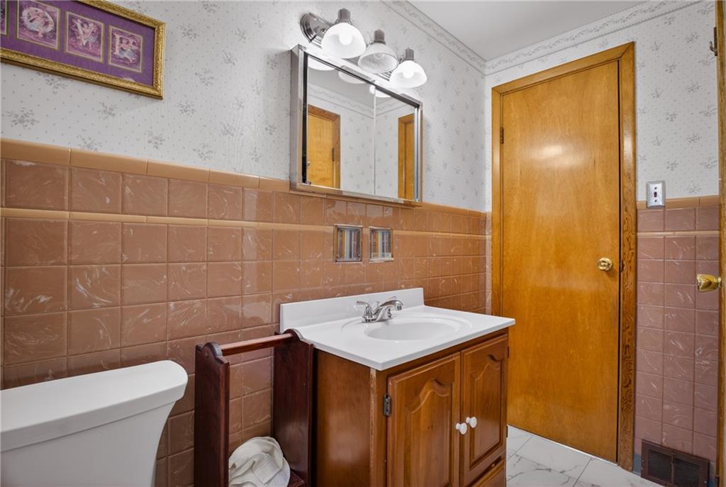 186 William Street McKees Rocks, PA 15136 - Photo 25 of 45 a bathroom with a sink a toilet and mirror