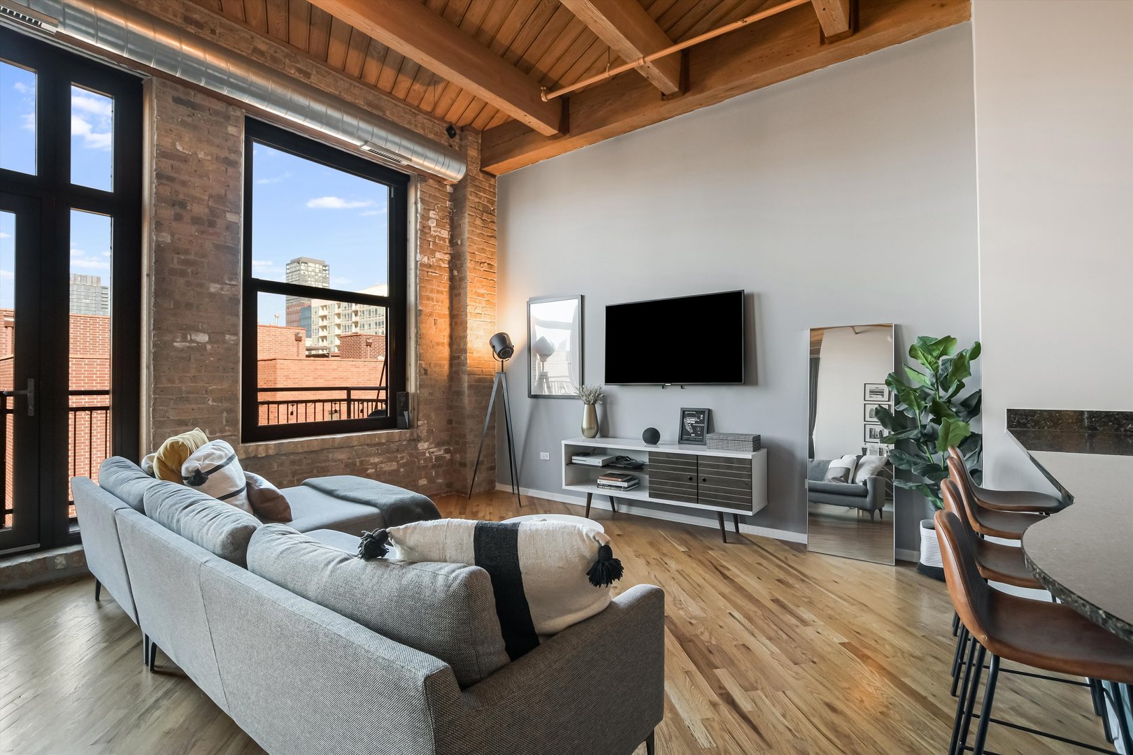 1040 West Adams Street, Unit 417 Chicago, IL 60607 - Photo 7 of 21 a living room with furniture and a flat screen tv
