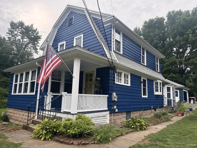 a view of a house with brick walls and flower plants