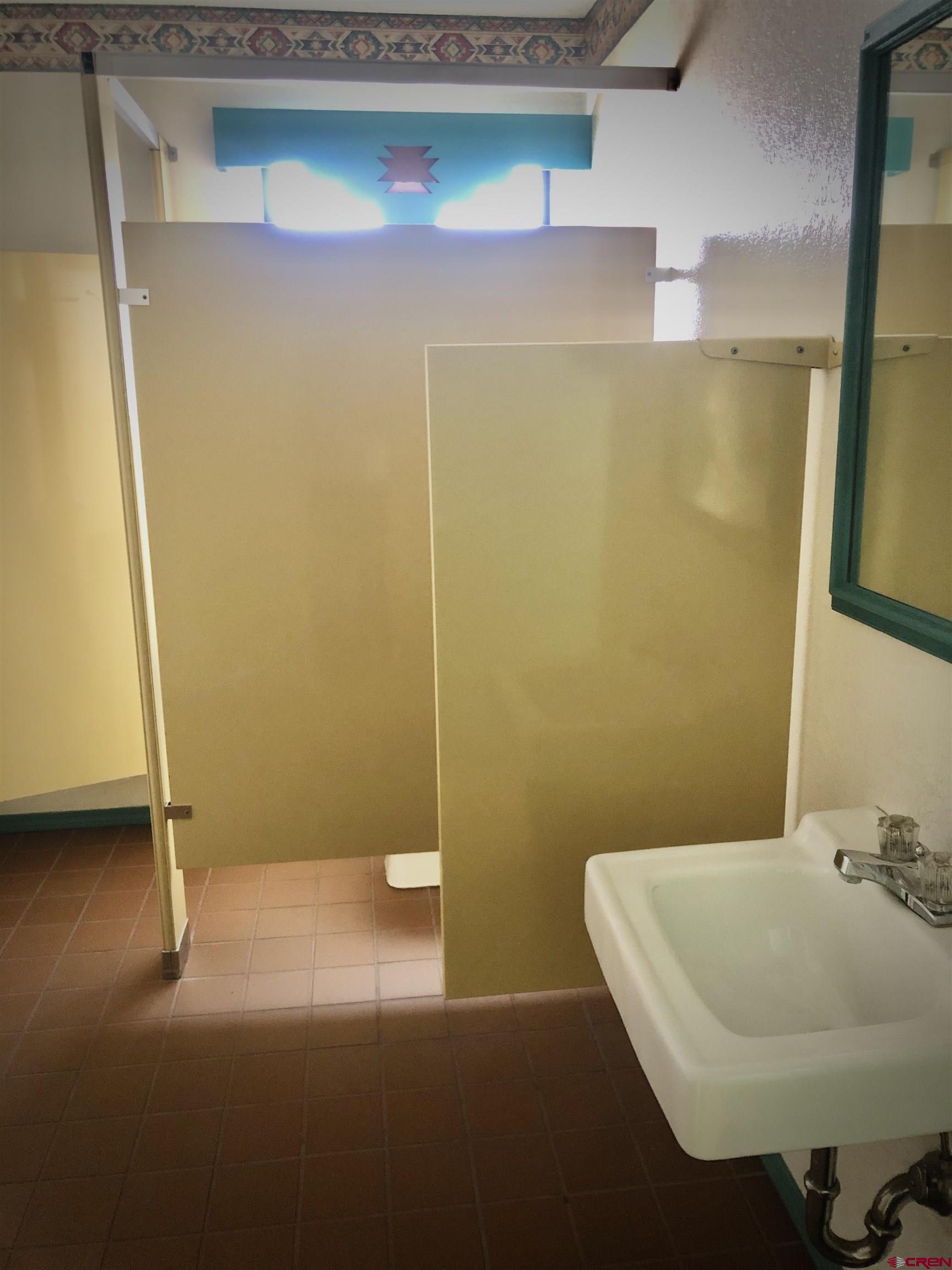 721 Main Street Delta, CO 81416 - Photo 15 of 17 a bathroom with a sink and a mirror