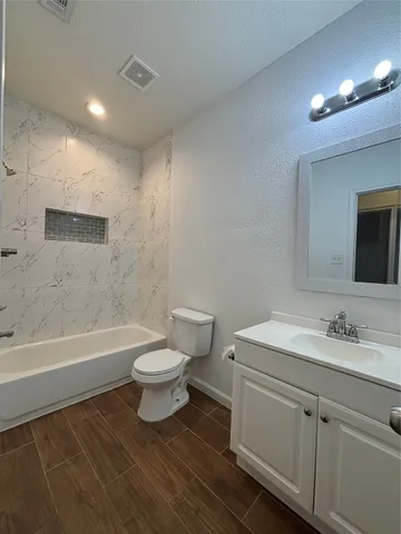 a bathroom with a sink a toilet and a bathtub
