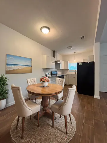 a view of a dining room with furniture and wooden floor