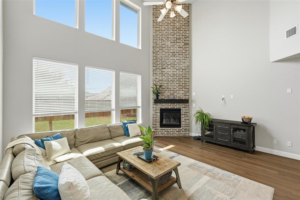 6212 Leatherstem Road Flower Mound, TX 76226 - Photo 7 of 40 Statement brick fireplace anchors the living space.