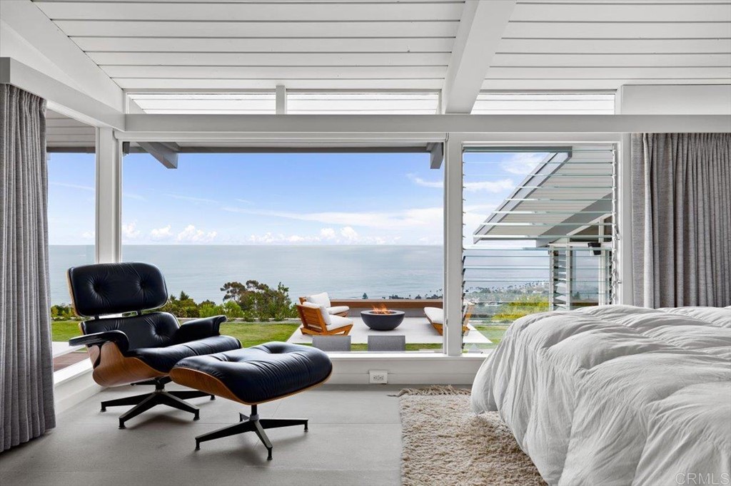 5972 Avenida Chamnez La Jolla, CA 92037 - Photo 5 of 9 a living room with a couch and a potted plant