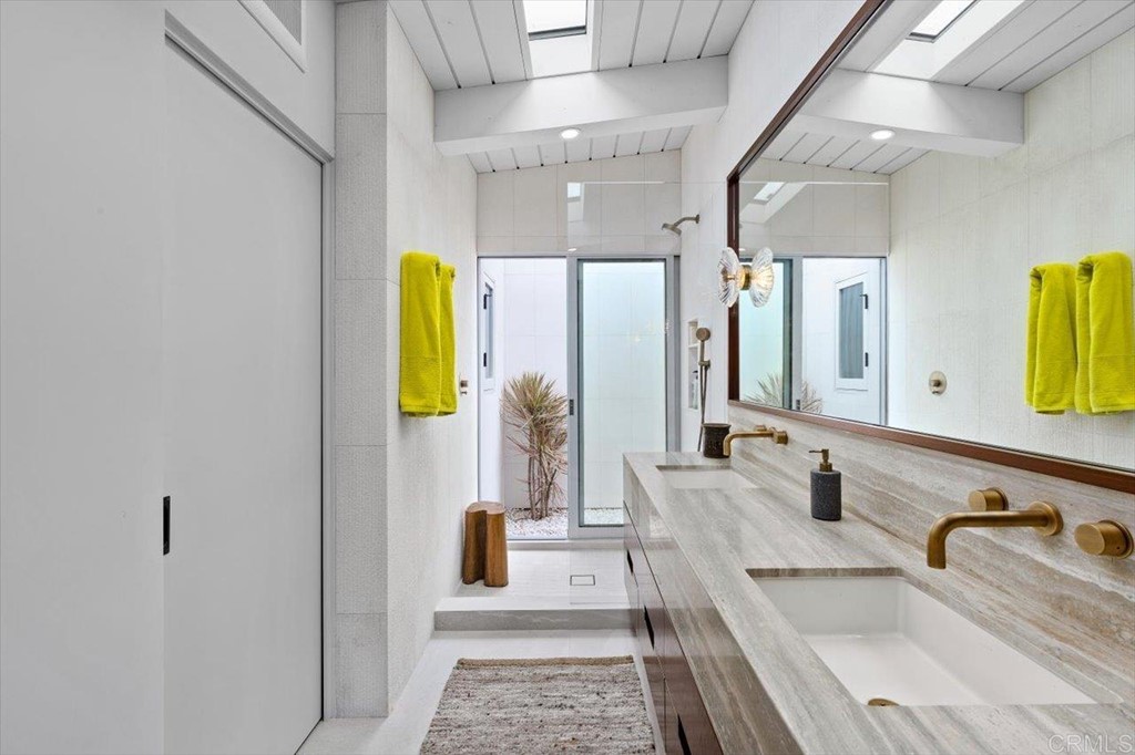 5972 Avenida Chamnez La Jolla, CA 92037 - Photo 6 of 9 a bathroom with a granite countertop sink and a mirror