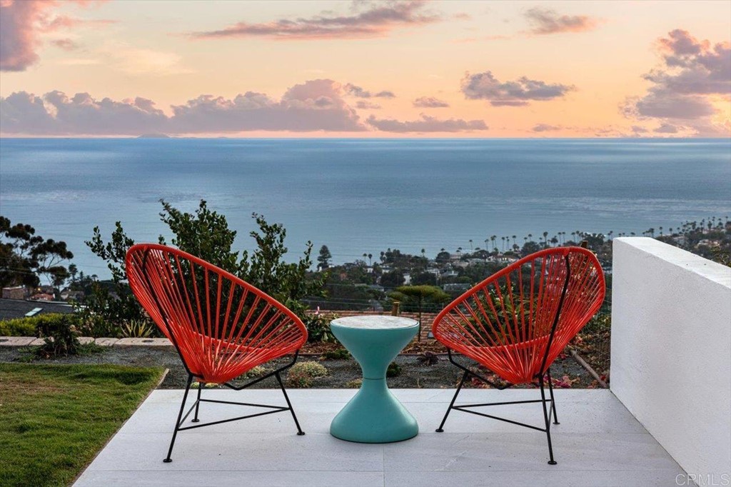 5972 Avenida Chamnez La Jolla, CA 92037 - Photo 7 of 9 a view of a chairs and table in patio with a lake view
