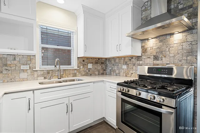 a kitchen that has a sink and a stove