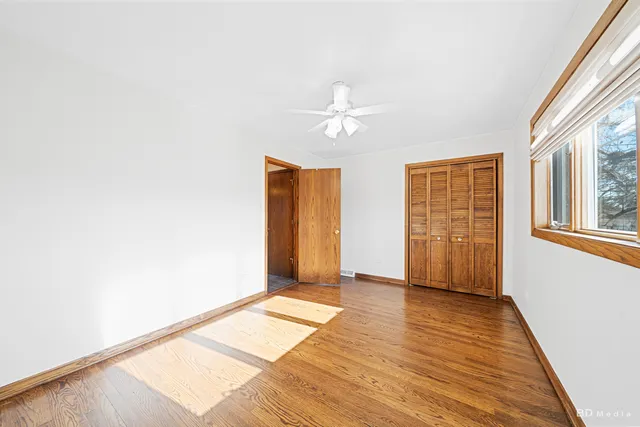 a bathroom with a sink a toilet and a large window