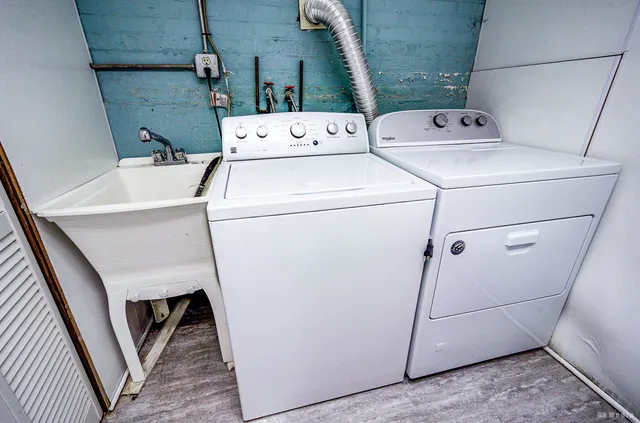 a view of empty room with wooden floor and furniture