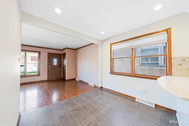 a kitchen with a refrigerator and white cabinets