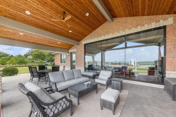 a kitchen with stainless steel appliances kitchen island granite countertop a kitchen island a stove a dining table and chairs