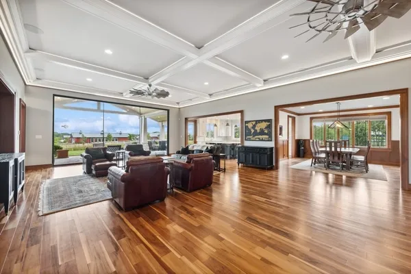 a large kitchen with kitchen island a sink a stove and a wooden floors