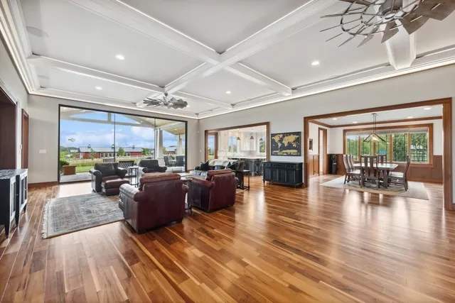 a large kitchen with kitchen island a sink a stove and a wooden floors