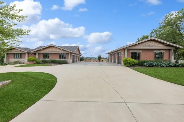 a front view of house with yard and green space