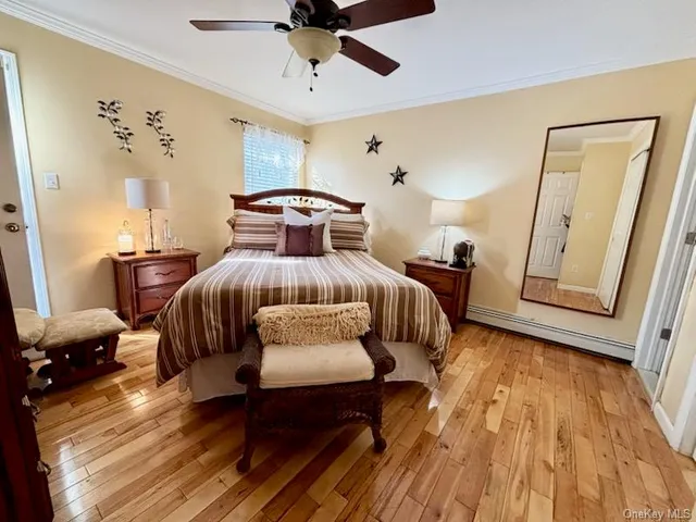 a bedroom with furniture and wooden floor