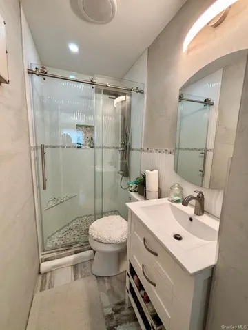 a bathroom with a sink toilet and shower