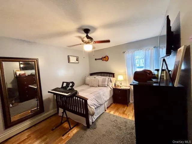a bedroom with a bed and a flat tv screen on the dresser