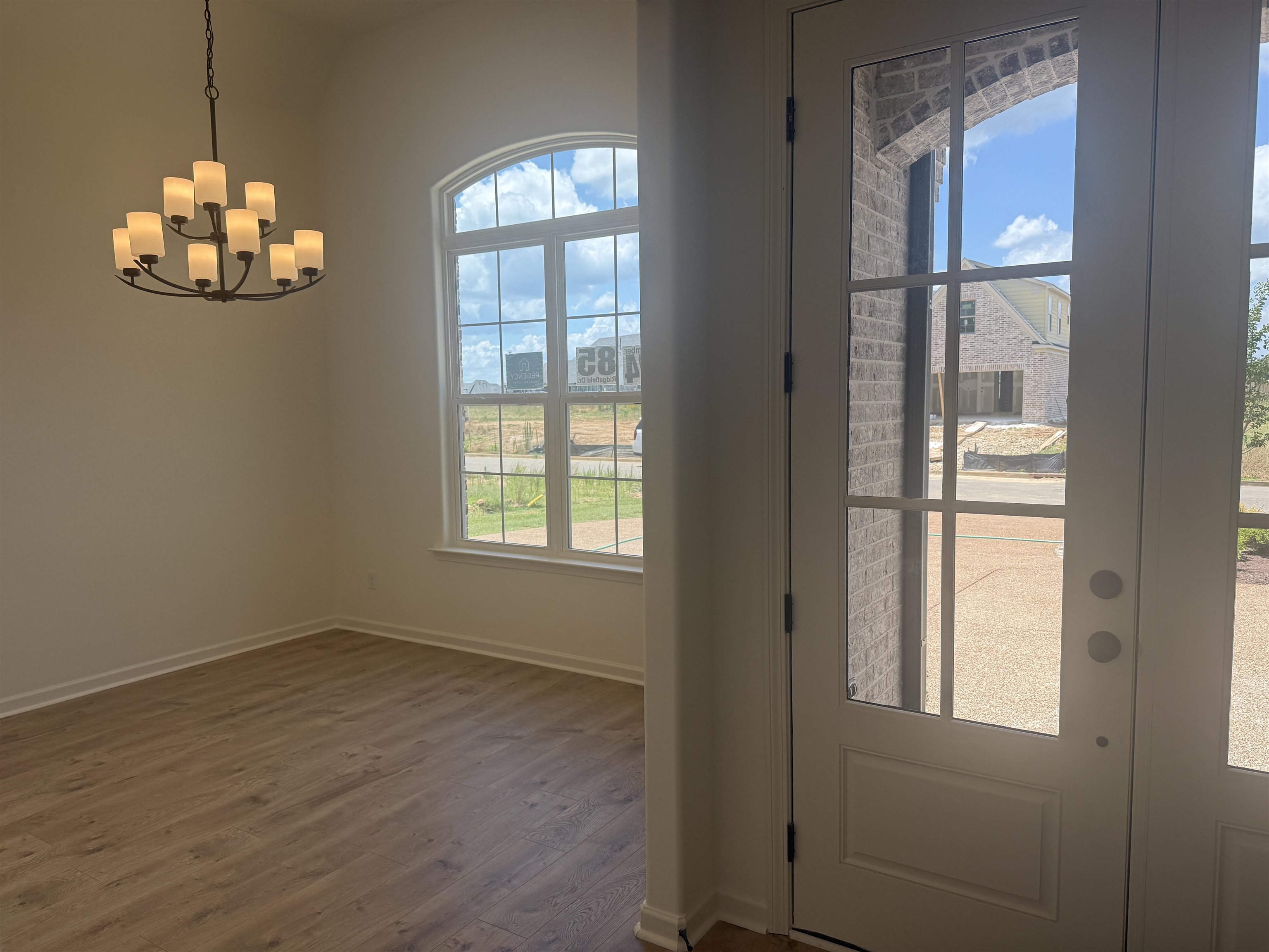 85 Ridgefield Drive Oakland, TN 38060 - Photo 6 of 12 an empty room with wooden floor and windows