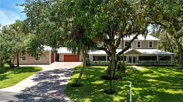 a front view of a house with yard and green space