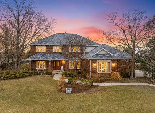 a front view of a house with a garden and sitting area
