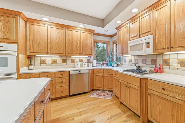 a kitchen with kitchen island granite countertop a sink appliances cabinets and a counter top space