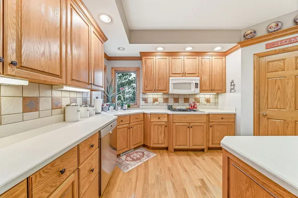 a kitchen with granite countertop a sink a stove and cabinets