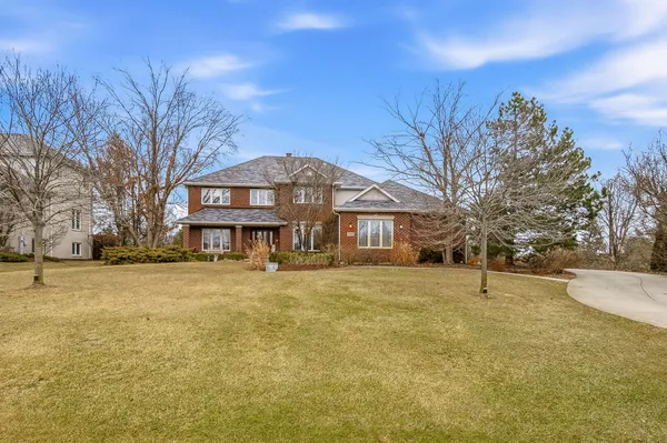 a front view of a building with a yard
