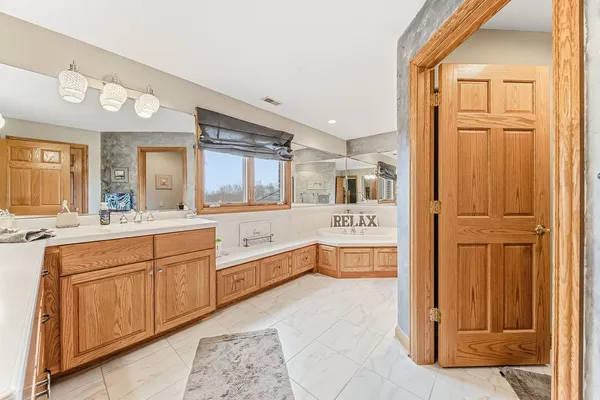 a large bathroom with a large tub and sink