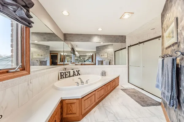 a bathroom with a sink a mirror and shower