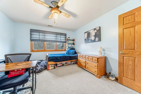 a bedroom with furniture and a window