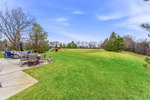a view of a backyard with sitting area