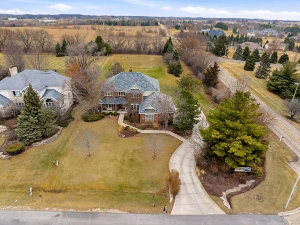 an aerial view of a house with a yard