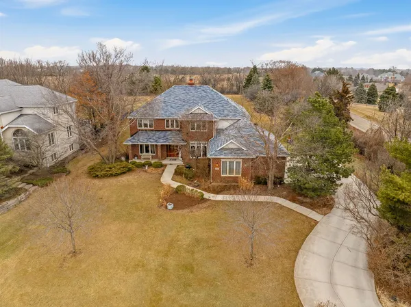 an aerial view of a house with a big yard