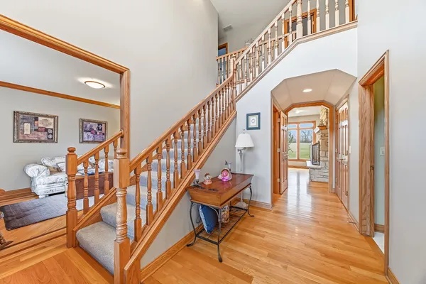 a view of entryway and hall with wooden floor
