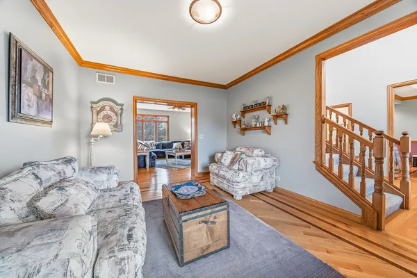 a bedroom with furniture and a wooden floor