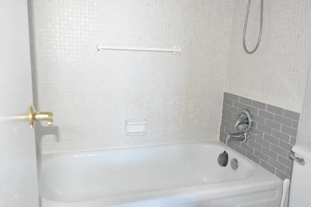 a front view of a house with a garden and swimming pool