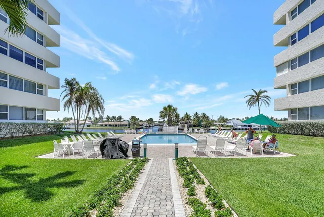 an aerial view of a multi story residential apartment building with yard