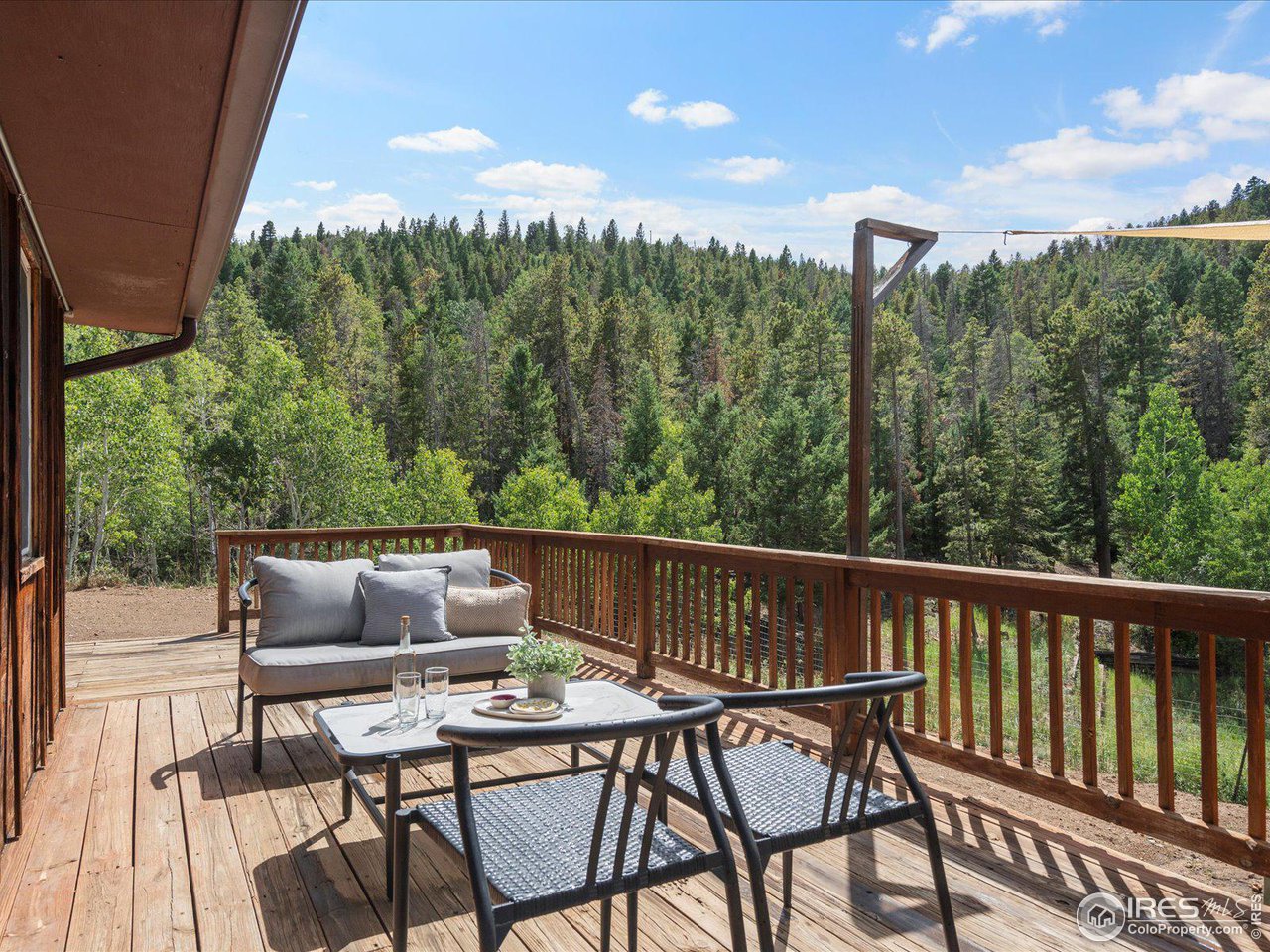 31851 Warrens Road Golden, CO 80403 - Photo 29 of 40 a view of a chairs and table in patio