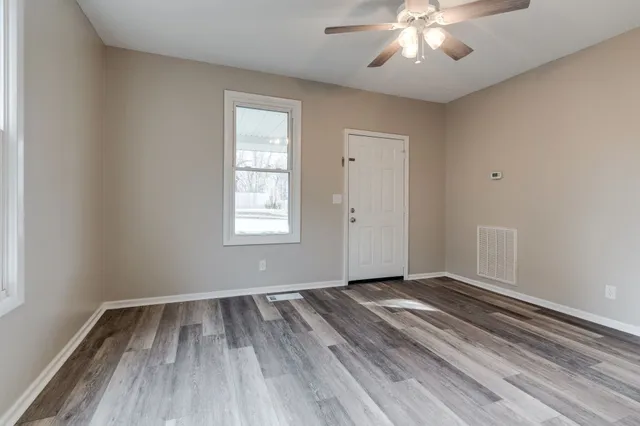wooden floor in an empty room with a window