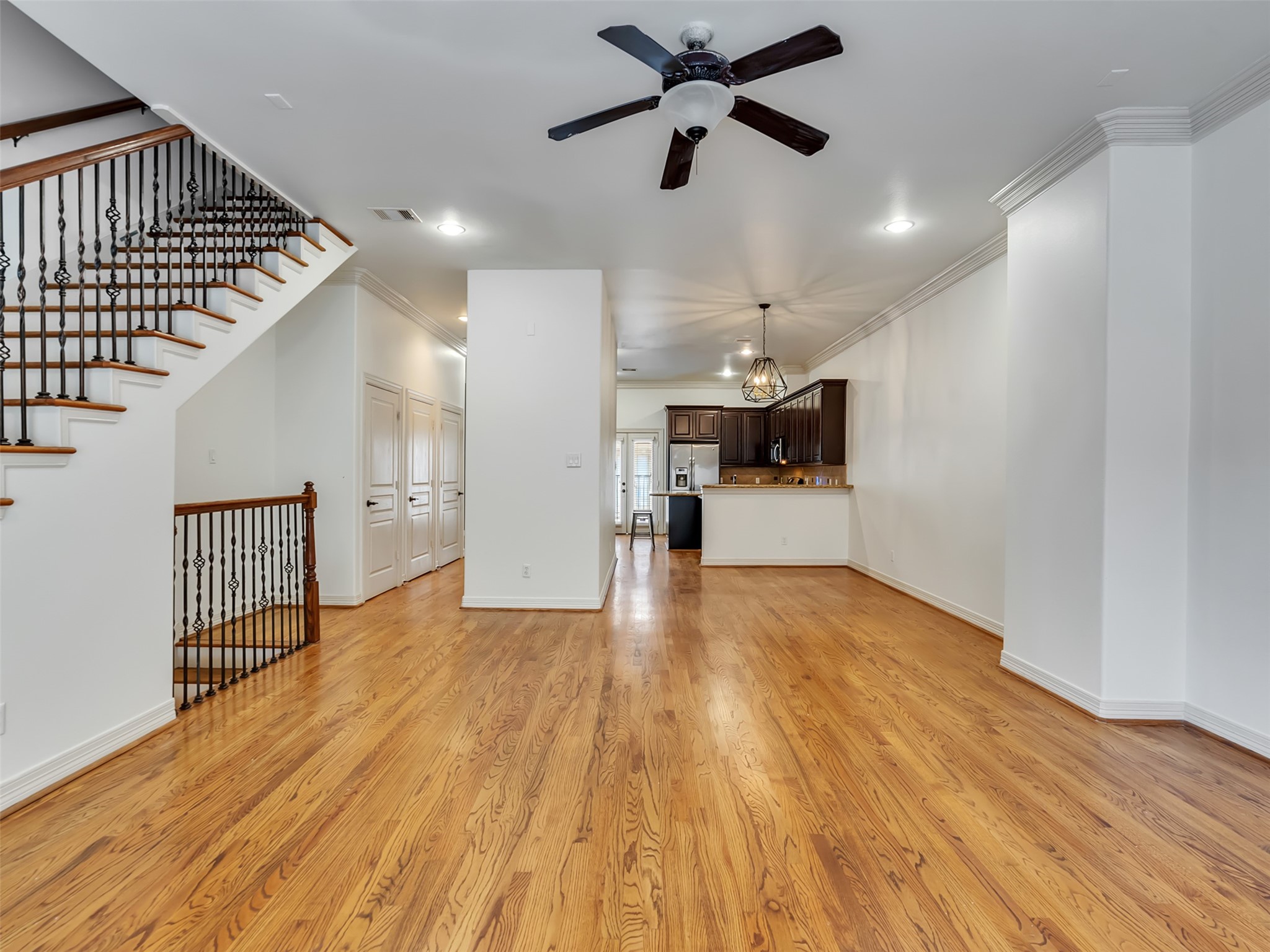 2540 Prospect Street, Unit B Houston, TX 77004 - Photo 17 of 37 a view of a hallway with wooden floor and a ceiling fan